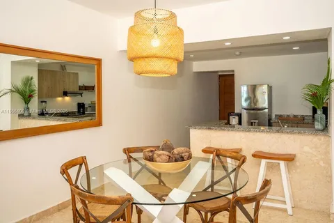 a view of a dining room with furniture and a chandelier