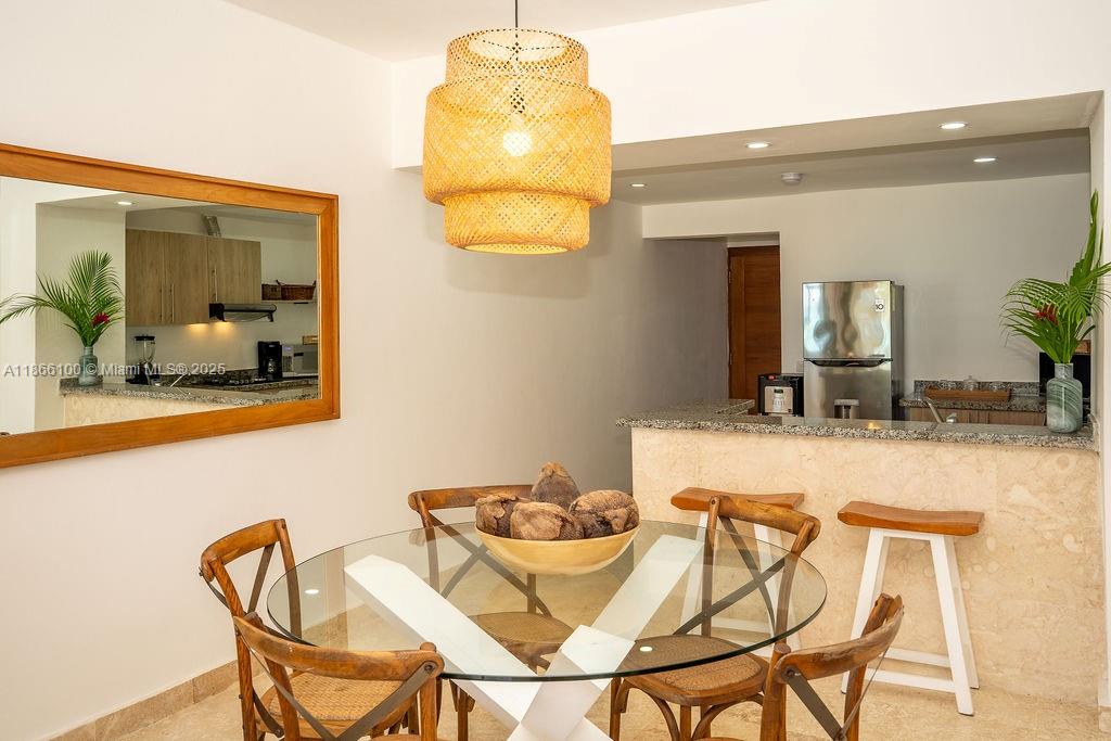 0 8c3f Q62 Las Terrenas Drive, Unit 2 Las Terrenas, Samaná Province 32000 - Photo 5 of 38 a view of a dining room with furniture and a chandelier
