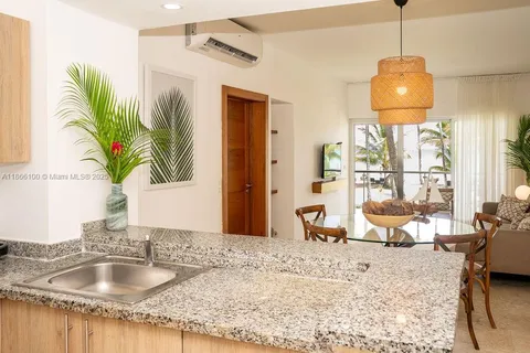 a bathroom with a granite countertop sink a large mirror and a window