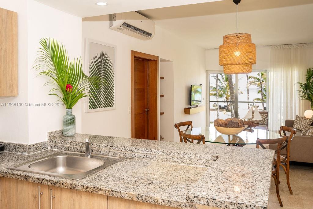 0 8c3f Q62 Las Terrenas Drive, Unit 2 Las Terrenas, Samaná Province 32000 - Photo 7 of 38 a bathroom with a granite countertop sink a large mirror and a window