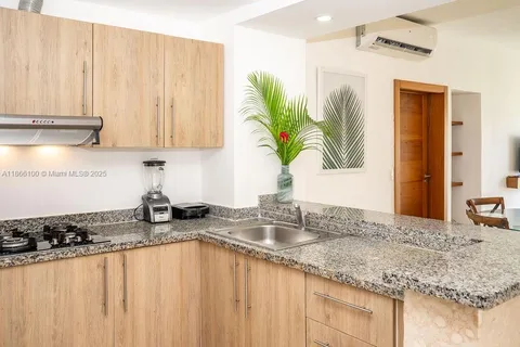 a kitchen with a sink a counter top space and a window