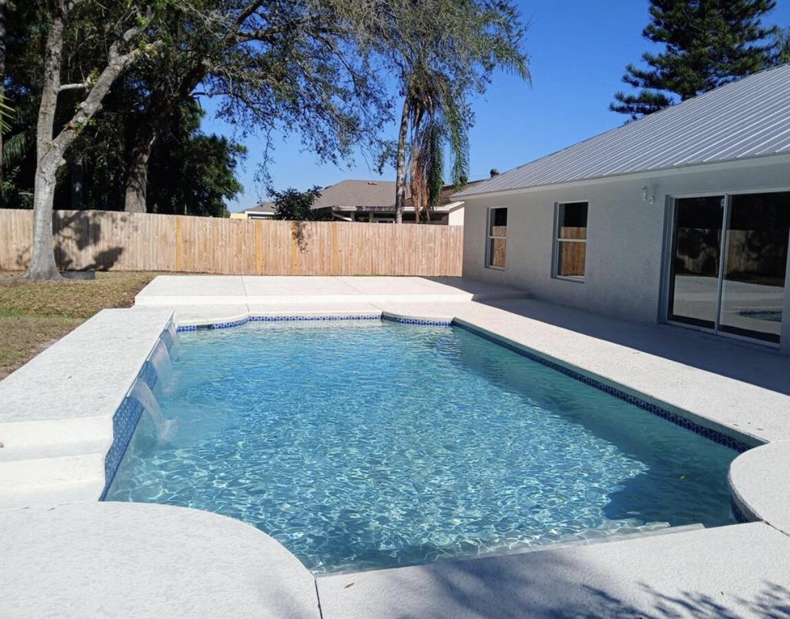 3450 Southwest Martin Street Port St. Lucie, FL 34953 - Photo 6 of 7 a view of a backyard with a large tree