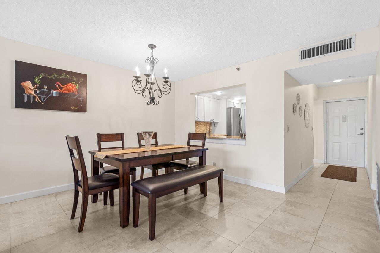 2070 Homewood Boulevard, Unit 4140 Delray Beach, FL 33445 - Photo 11 of 28 a view of a dining room with furniture