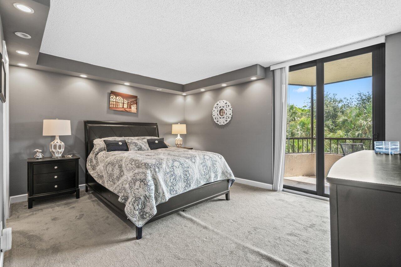 2070 Homewood Boulevard, Unit 4140 Delray Beach, FL 33445 - Photo 13 of 28 a bedroom with a large bed and a large window