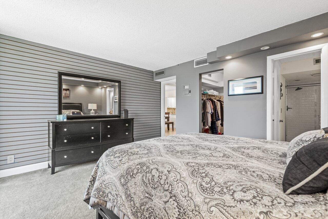 2070 Homewood Boulevard, Unit 4140 Delray Beach, FL 33445 - Photo 15 of 28 a bedroom with a bed and a flat screen tv