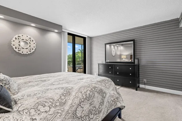 a bathroom with a granite countertop sink mirror and toilet