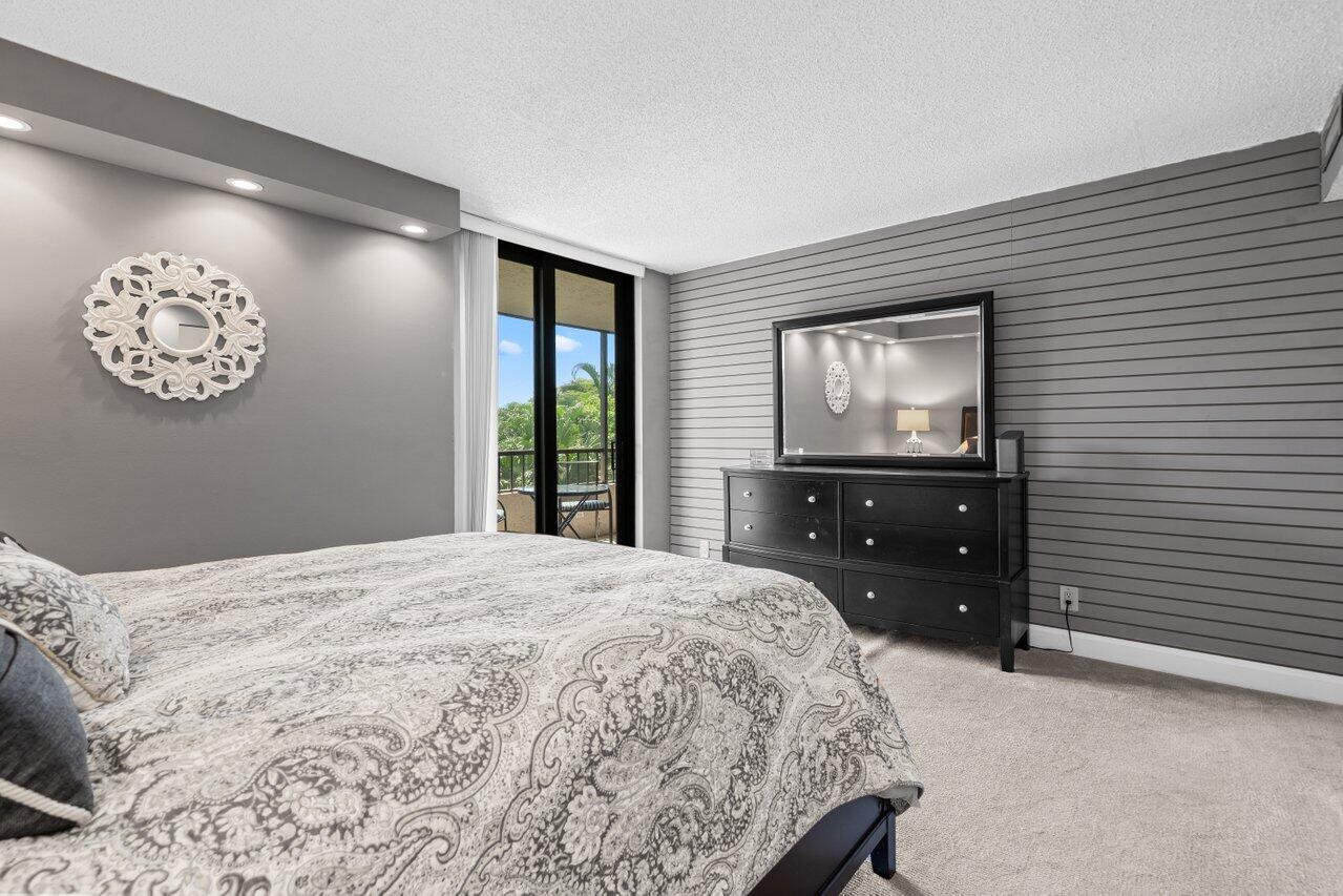 2070 Homewood Boulevard, Unit 4140 Delray Beach, FL 33445 - Photo 16 of 28 a bedroom with a bed and a window