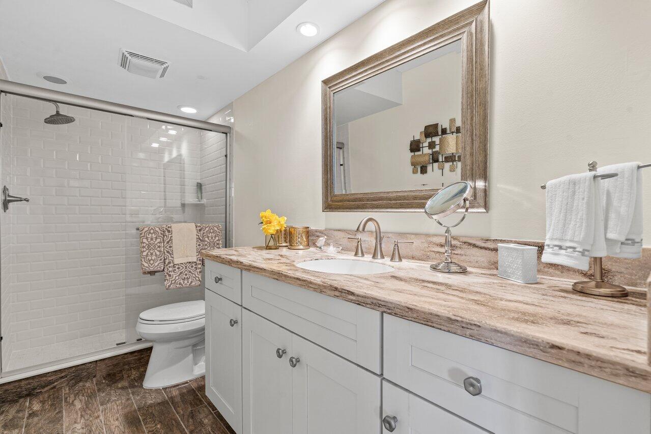 2070 Homewood Boulevard, Unit 4140 Delray Beach, FL 33445 - Photo 17 of 28 a bathroom with a granite countertop sink mirror and toilet