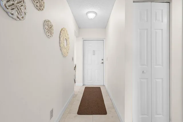 a walk in closet with wooden floor