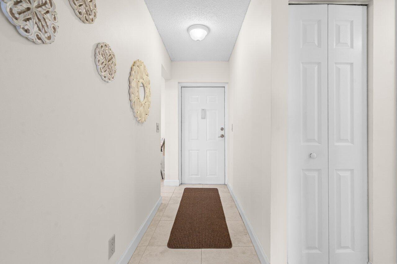 2070 Homewood Boulevard, Unit 4140 Delray Beach, FL 33445 - Photo 2 of 28 a walk in closet with wooden floor