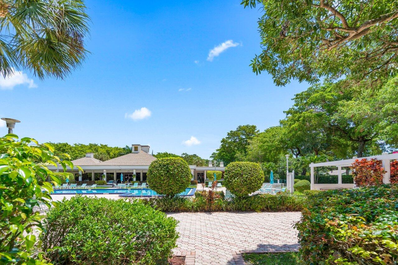 2070 Homewood Boulevard, Unit 4140 Delray Beach, FL 33445 - Photo 27 of 28 a view of a garden with a building in the background