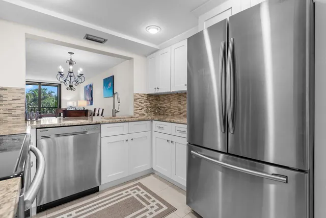 a kitchen with stainless steel appliances a refrigerator and a sink