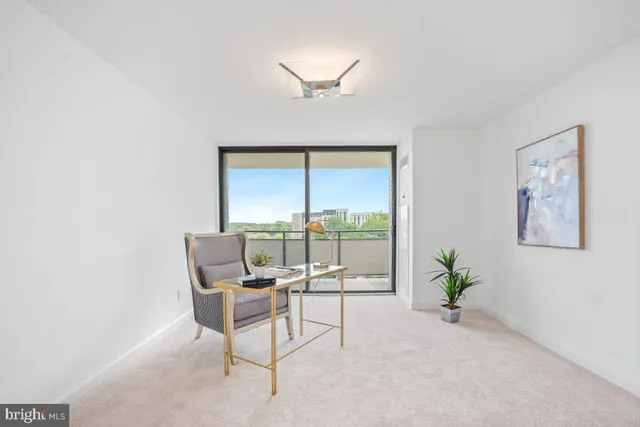 a dining room with furniture and a large window