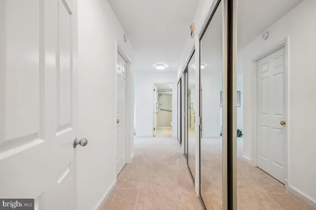 a view of a hallway with wooden shelves