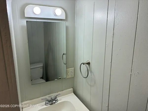 a white toilet sitting next to a small sink