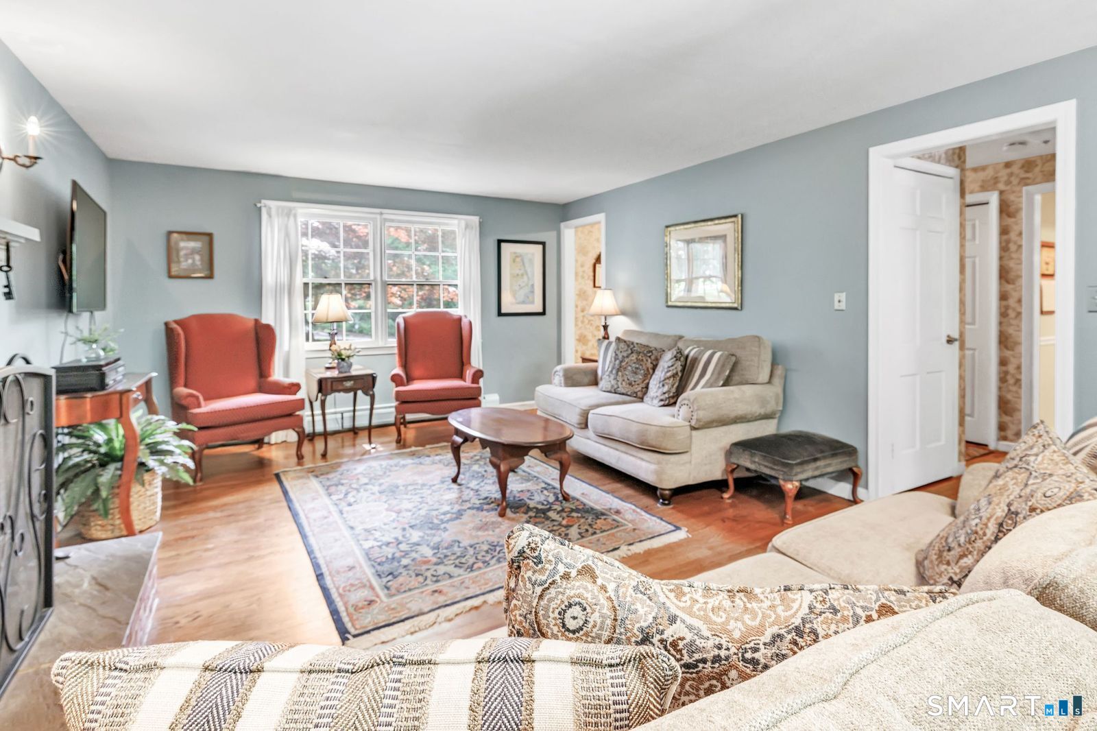 21 Overlook Place Trumbull, CT 06611 - Photo 3 of 37 Spacious living room with classic wood-burning fireplace, hardwood flooring and several windows allowing for lots of natural light.