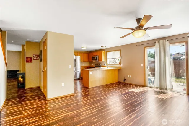 a view of a kitchen with wooden floor and a kitchen