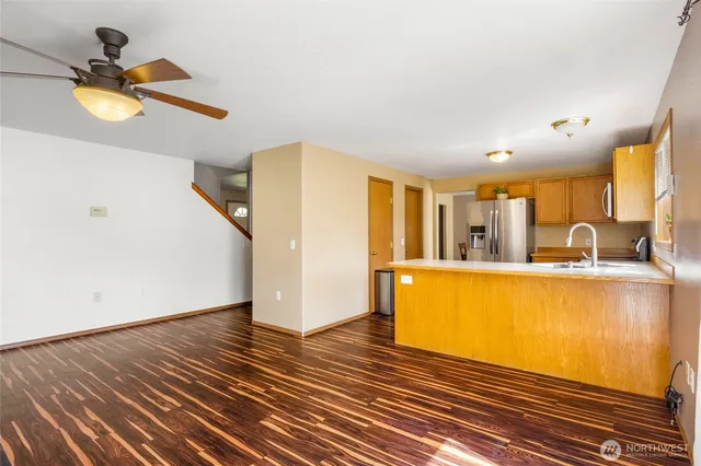 a view of a room with wooden floor and a window