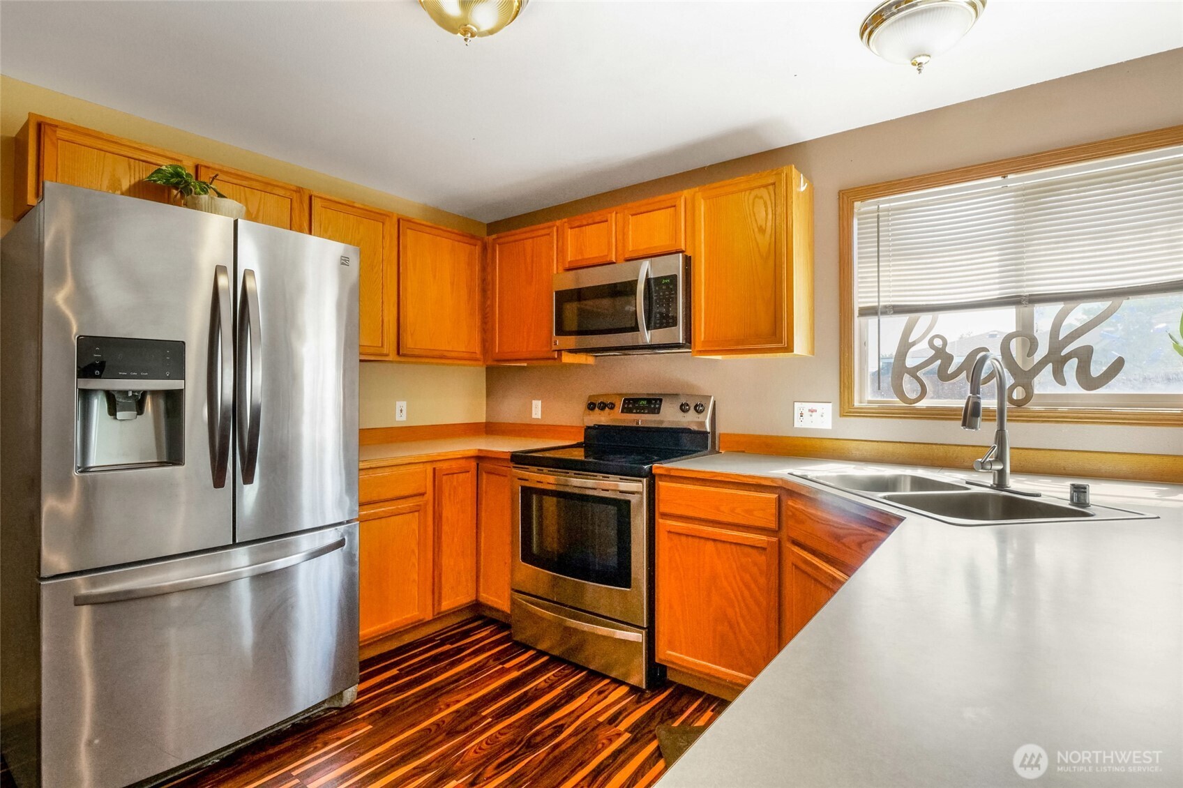 804 Sycamore Lane Moses Lake, WA 98837 - Photo 14 of 40 a kitchen with stainless steel appliances granite countertop a refrigerator a stove a sink and a microwave