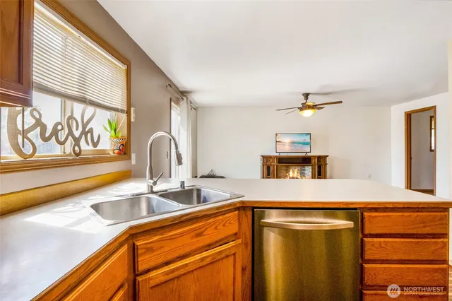 a kitchen with stainless steel appliances granite countertop a sink and a stove