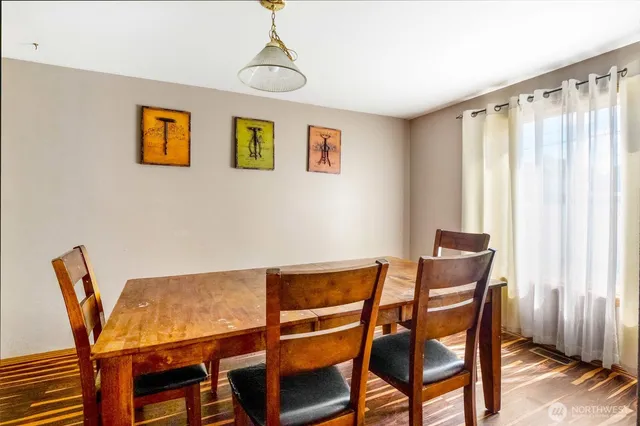 a view of a dining room with furniture and window