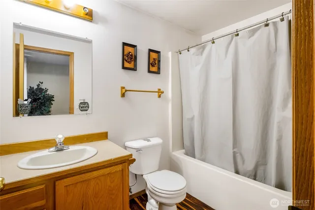 a bathroom with a sink a mirror a toilet and a mirror