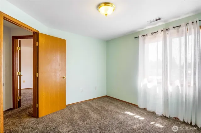 a view of a room with a window and brick walls