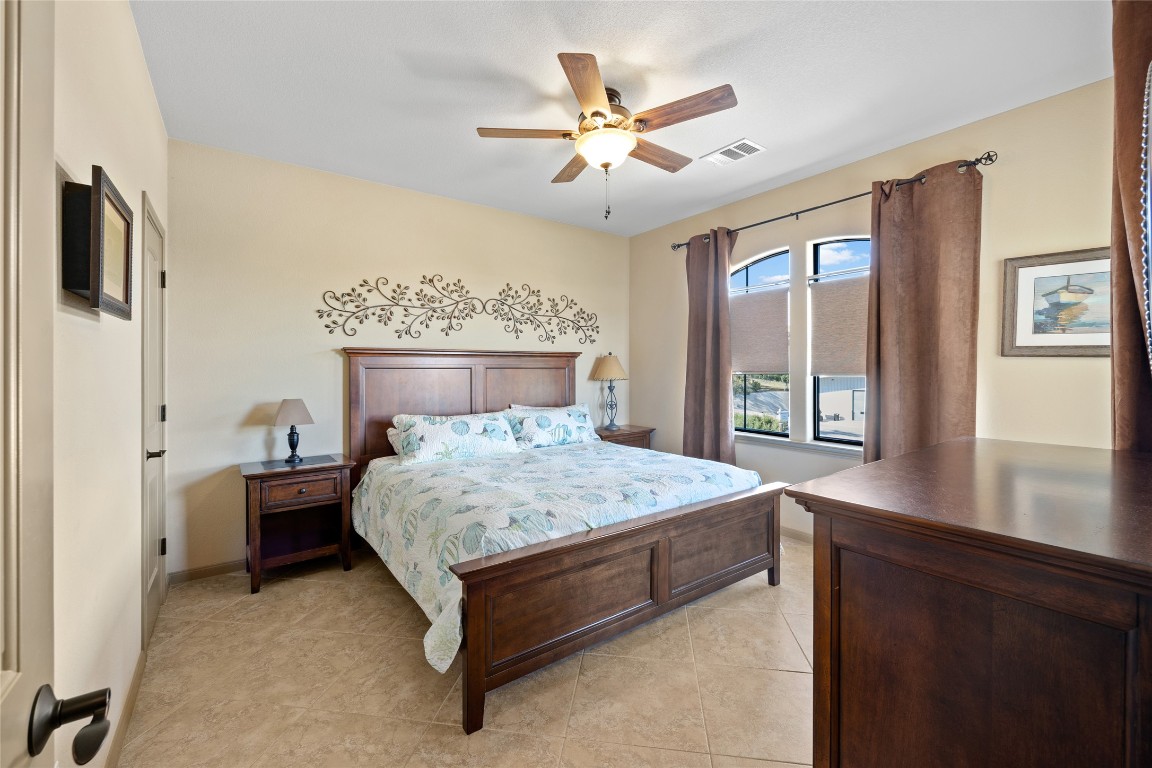 1690 Hickory Creek Road Marble Falls, TX 78654 - Photo 10 of 25 Bedroom featuring ceiling fan and light tile patterned floors