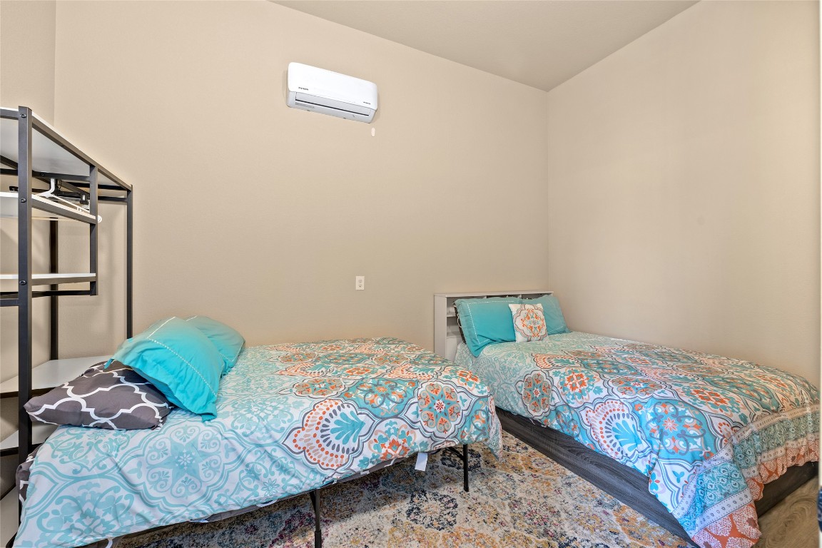 1690 Hickory Creek Road Marble Falls, TX 78654 - Photo 19 of 25 Bedroom featuring an AC wall unit
