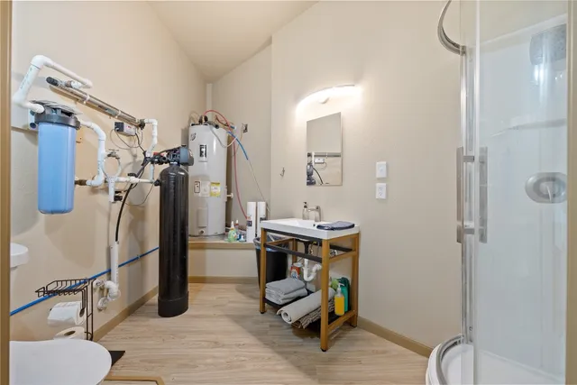a bedroom with two beds and painting on the wall
