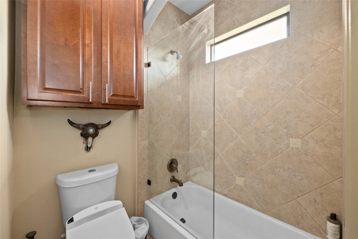 1690 Hickory Creek Road Marble Falls, TX 78654 - Photo 9 of 25 Bathroom featuring shower / washtub combination and toilet