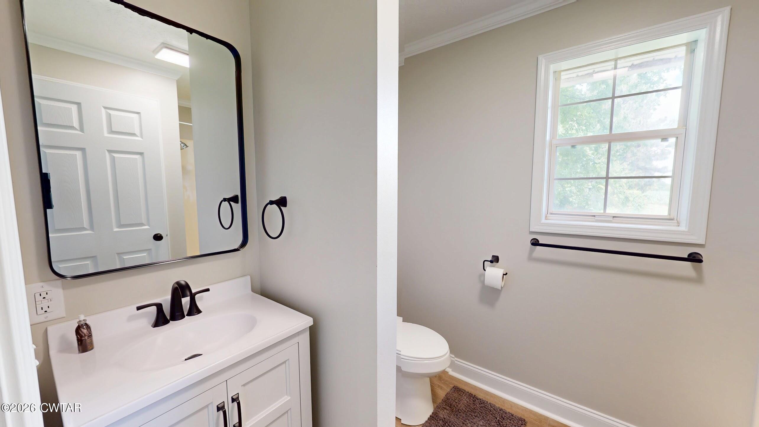 2800 Locust Grove Road Newbern, TN 38059 - Photo 37 of 46 a bathroom with a sink a toilet and a mirror