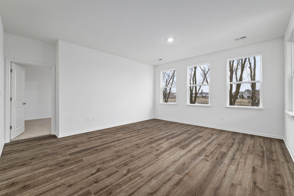7676 West 106th Place Crown Point, IN 46307 - Photo 6 of 13 a view of empty room with wooden floor and fan