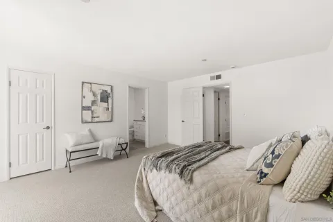 a bedroom with a bed and a couch