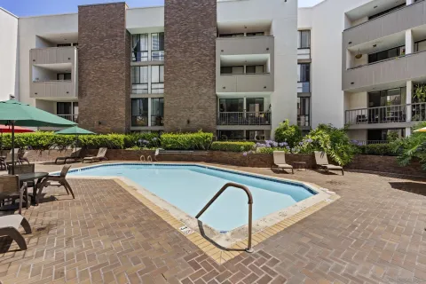 a view of a house with swimming pool and sitting area
