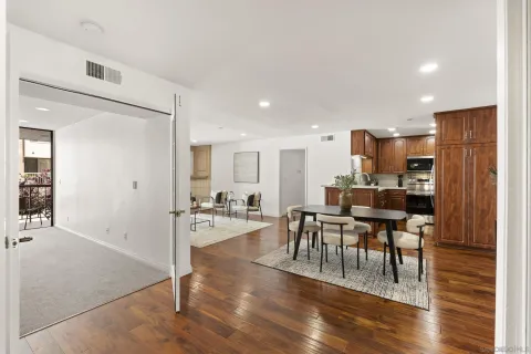 a view of a dining room with furniture and wooden floor