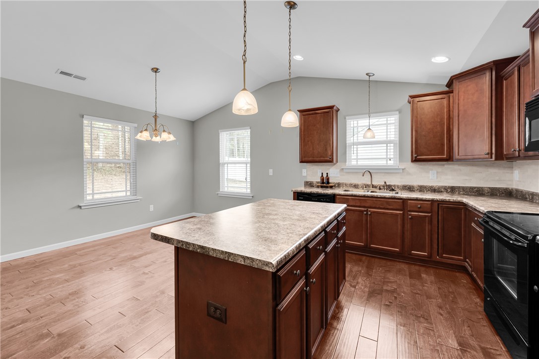 138 Madison Pointe Drive Seneca, SC 29678 - Photo 13 of 42 This spacious kitchen offers rich wood cabinetry, ample counter space, and durable hardwood flooring.