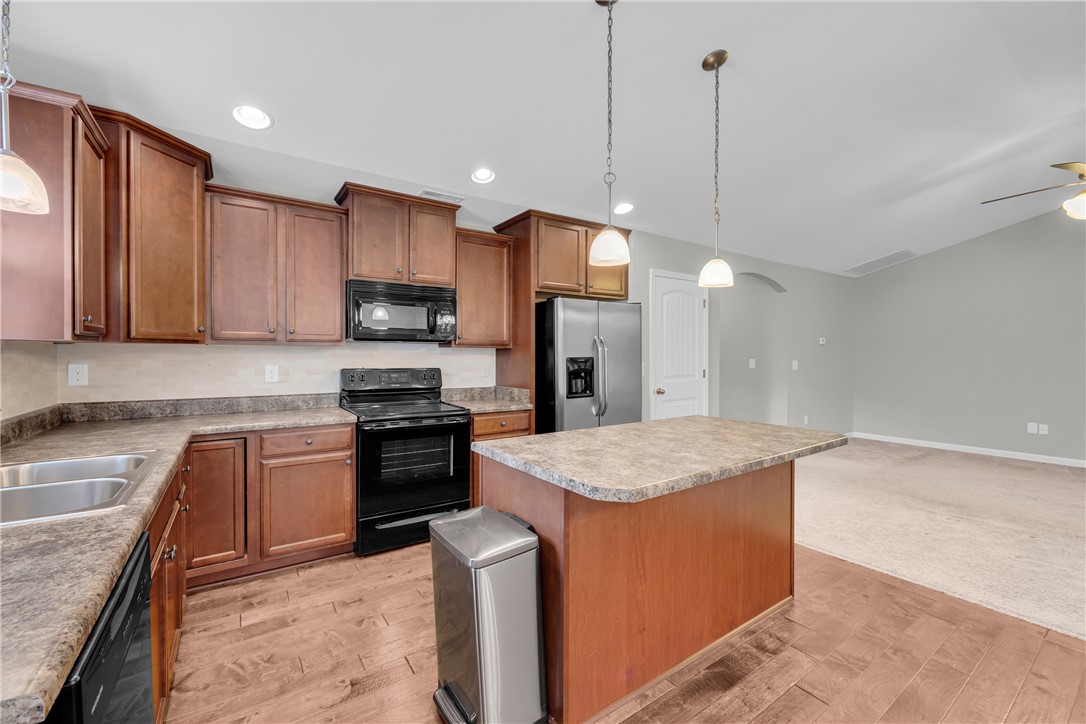 138 Madison Pointe Drive Seneca, SC 29678 - Photo 15 of 42 This functional kitchen features ample cabinetry and a practical island, flowing into a comfortable living area.