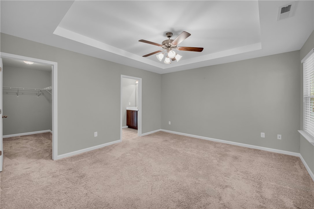 138 Madison Pointe Drive Seneca, SC 29678 - Photo 16 of 42 This spacious bedroom offers comfortable carpeting and a tray ceiling, ready for your personal touch.