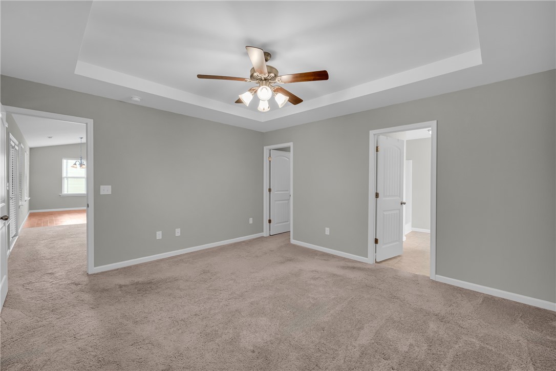 138 Madison Pointe Drive Seneca, SC 29678 - Photo 17 of 42 An inviting room features plush carpeting and a refined tray ceiling.