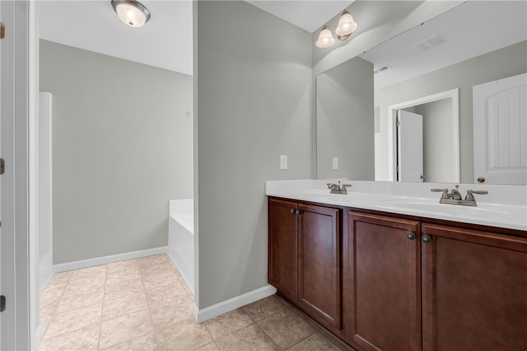 138 Madison Pointe Drive Seneca, SC 29678 - Photo 20 of 42 This bathroom features a double vanity and sleek fixtures.
