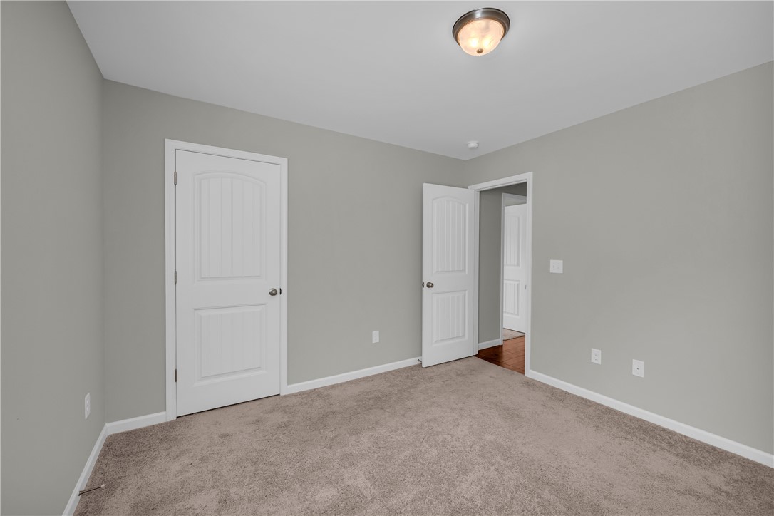 138 Madison Pointe Drive Seneca, SC 29678 - Photo 28 of 42 This inviting bedroom features soft carpet and bright doors, creating a serene and comfortable retreat.