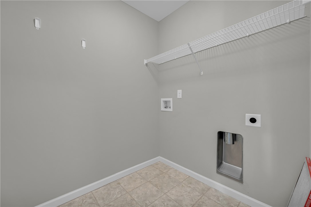 138 Madison Pointe Drive Seneca, SC 29678 - Photo 30 of 42 This dedicated laundry space features practical utility connections and durable tile flooring for everyday convenience.