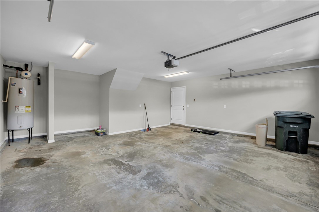 138 Madison Pointe Drive Seneca, SC 29678 - Photo 34 of 42 This spacious garage offers ample room for vehicles and storage, featuring durable concrete flooring.