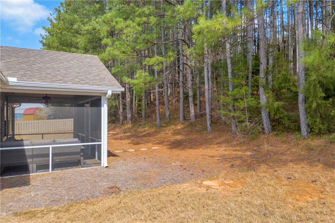 138 Madison Pointe Drive Seneca, SC 29678 - Photo 40 of 42 This private backyard features a screened porch, perfect for enjoying outdoor living surrounded by nature.