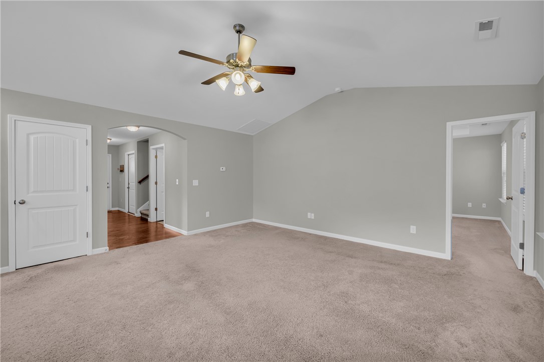 138 Madison Pointe Drive Seneca, SC 29678 - Photo 6 of 42 This expansive living area offers versatile design possibilities with comfortable carpeting and a high vaulted ceiling.