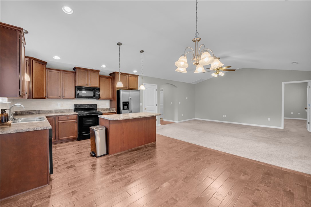 138 Madison Pointe Drive Seneca, SC 29678 - Photo 10 of 42 This kitchen features rich wood cabinetry, stainless steel appliances, and a breakfast bar opening to a spacious living area.