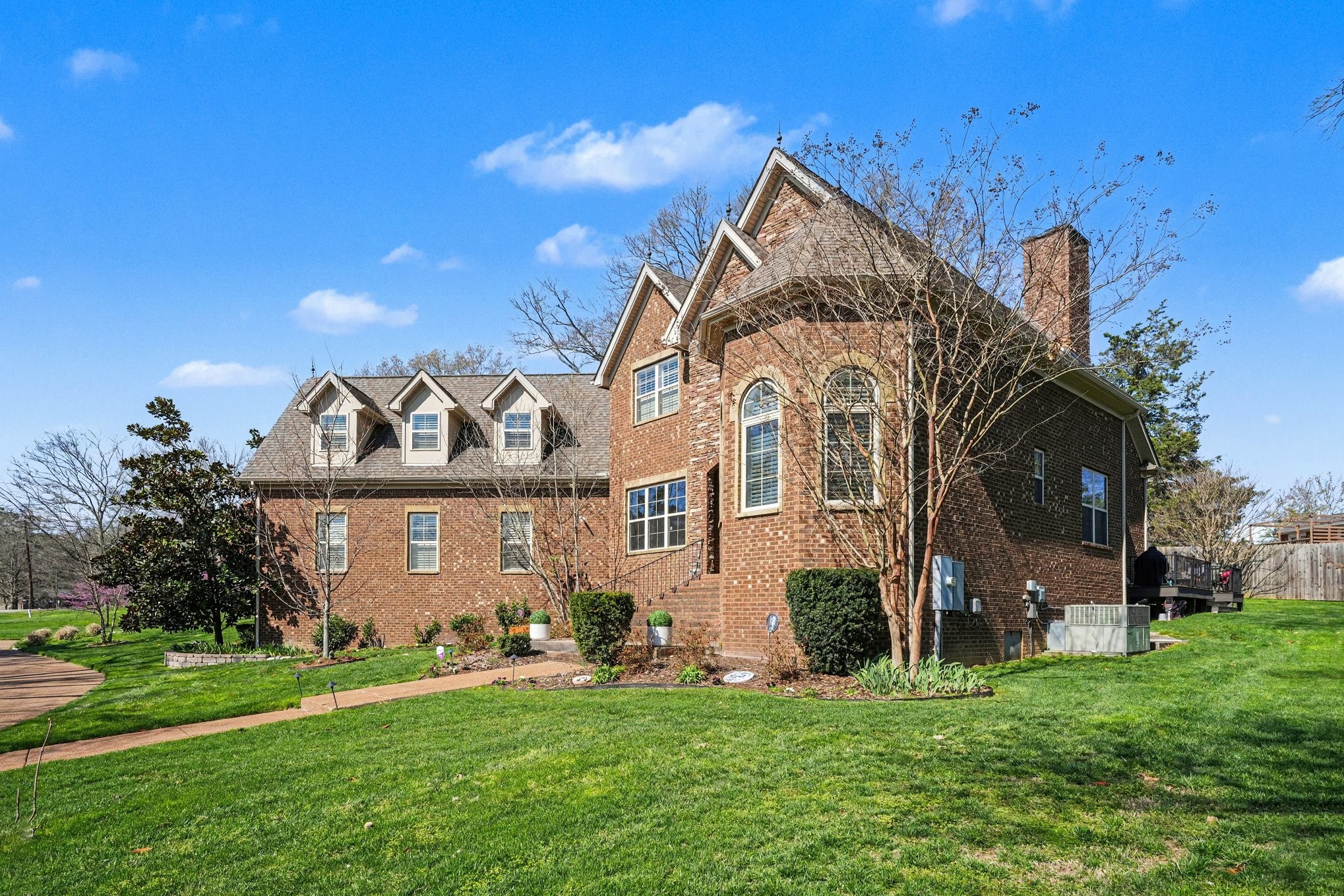a front view of a house with a garden