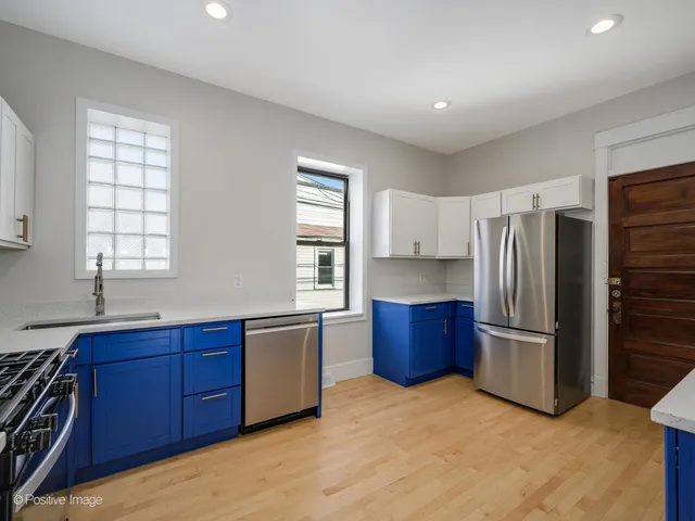 a kitchen with stainless steel appliances granite countertop a refrigerator and a sink