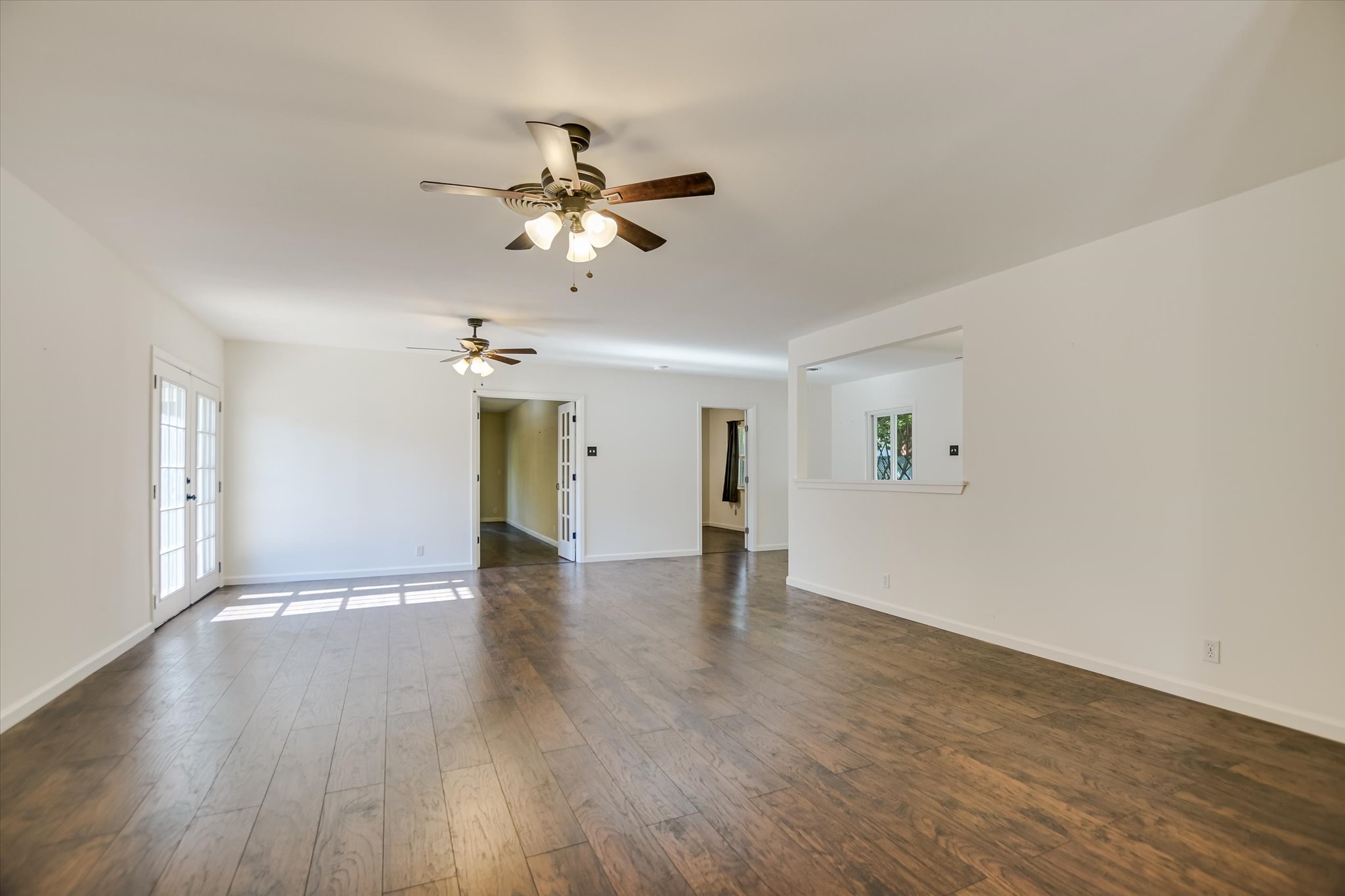 1601 East 19th Street Georgetown, TX 78626 - Photo 6 of 31 a view of an empty room with window and wooden floor